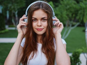 Portrait of young woman standing outdoors