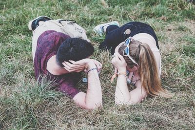 People relaxing on grassy field