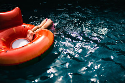 5 years old girl diving from a float in the pool