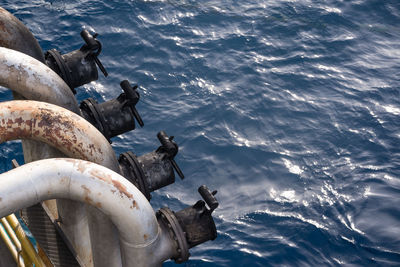 High angle view of pipes over sea