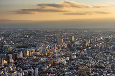 High angle view of modern buildings against sky during sunset