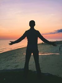 Silhouette of man standing on beach