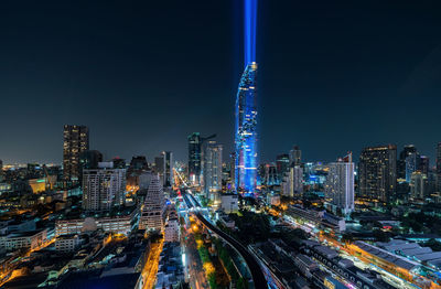 Aerial view of illuminated buildings in city at night