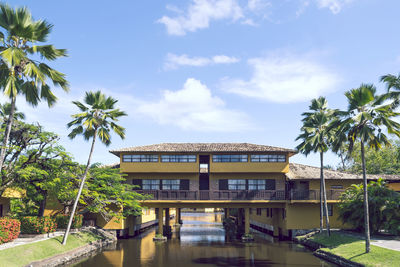 View of swimming pool by building against sky