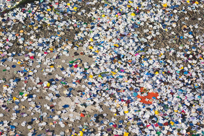 Full frame shot of multi colored confetti on field