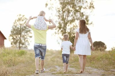 Rear view of family walking outdoors