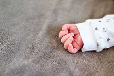 Low section of baby girl lying on floor