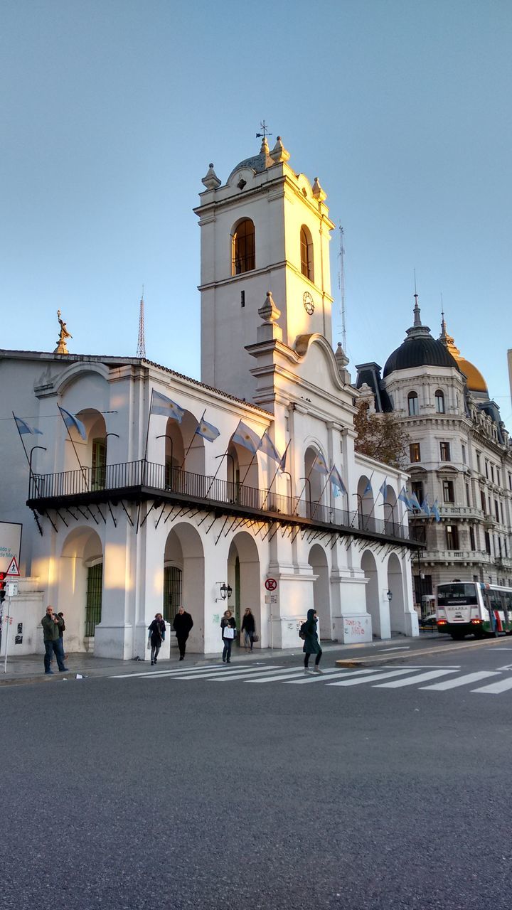 architecture, building exterior, built structure, church, place of worship, religion, clear sky, spirituality, blue, facade, dome, walking, cathedral, sky, incidental people, travel destinations, men