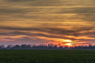 Scenic view of field against sky during sunset