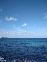 Scenic view of sea against blue sky