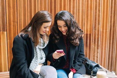 Young woman using mobile phone outdoors