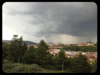 Buildings against cloudy sky