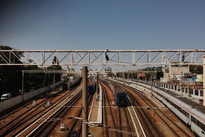 Railroad tracks in city against clear sky