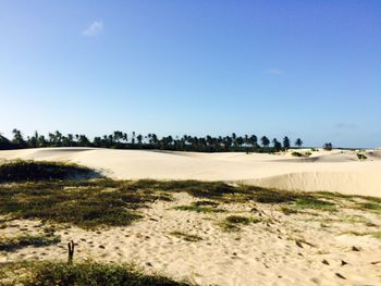 Scenic view of desert against clear blue sky