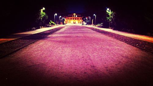 Illuminated tunnel at night