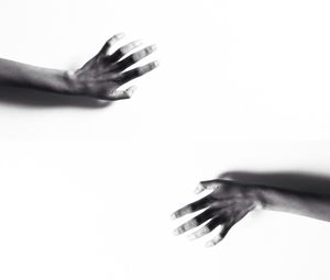 Cropped image of hand holding over white background