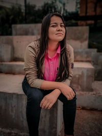 Portrait of beautiful young woman standing outdoors