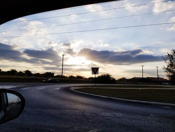 Street against sky at sunset