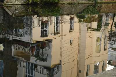 High angle view of buildings by trees in city