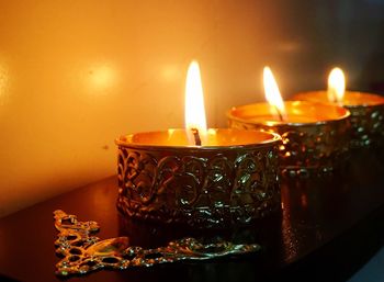 Close-up of lit tea light candles on table