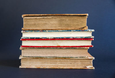 Close-up of books on table against black background