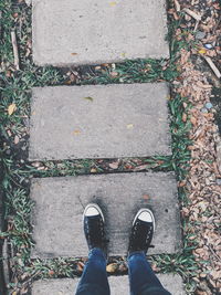 Low section of person standing on footpath