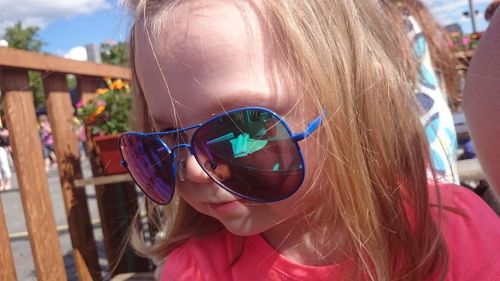 Close-up portrait of woman wearing sunglasses