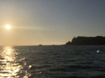 Scenic view of sea against clear sky during sunset