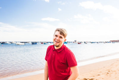 Portrait of young man standing on beach