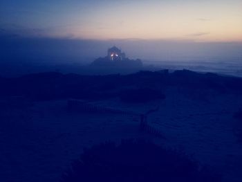 Scenic view of landscape against sky at sunset