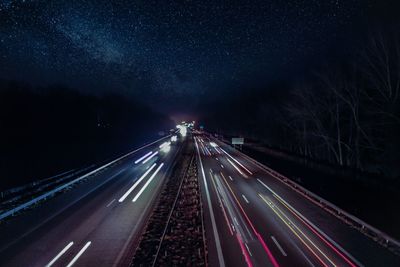 High angle view of light trails on highway at night