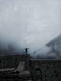 Low angle view of man standing against sky