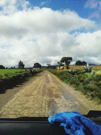 Road amidst trees against sky