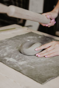 Cropped hand of woman working in workshop