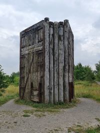 Old stone wall on field against sky