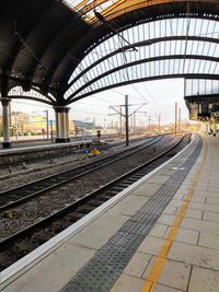Empty railroad station platform against sky