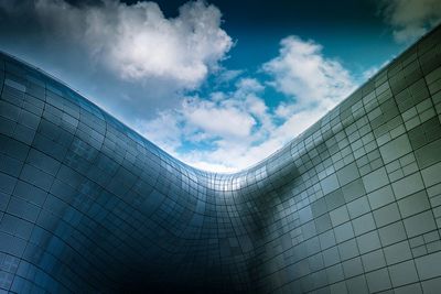 Low angle view of building against cloudy sky