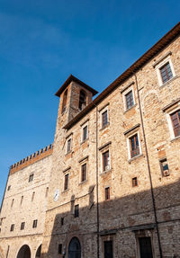 Low angle view of old building against blue sky