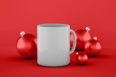 Close-up of tea cup on table against red background