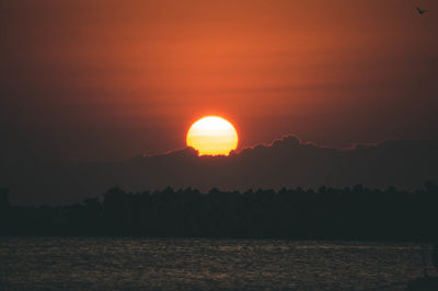 Scenic view of sea against romantic sky at sunset