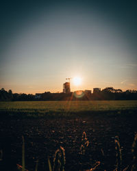 Scenic view of field against sky during sunset