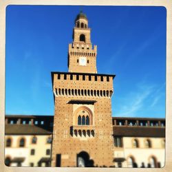 Low angle view of bell tower against blue sky