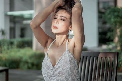 Portrait of young woman standing outdoors