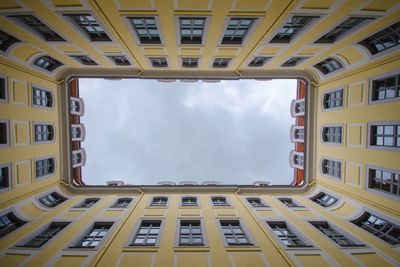 Low angle view of building against cloudy sky