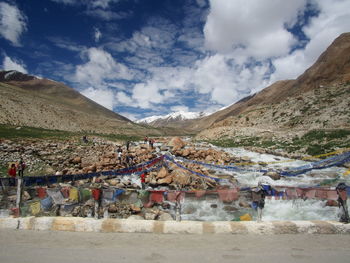 Group of people on land against mountain range