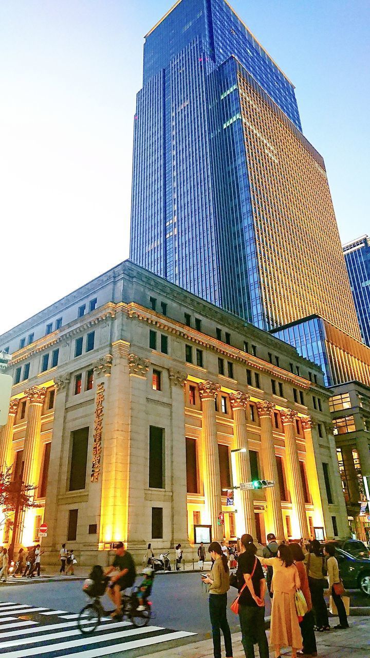 LOW ANGLE VIEW OF PEOPLE IN MODERN BUILDING