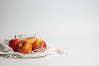 Close-up of fruits in plate against white background