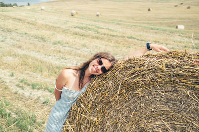 Portrait of woman standing on field