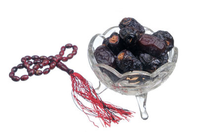 High angle view of berries on white background