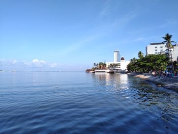 Scenic view of sea by building against sky